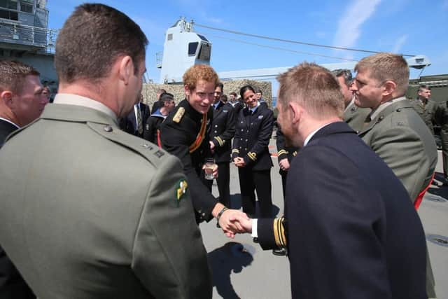 Prince Harry meets crew members as he attends a reception on HMS Bulwark with relatives of veterans of the Gallipoli Campaign