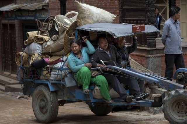 Rescue teams search in debris of collapsed houses after Saturday's earthquake in Bhaktapur, Nepal