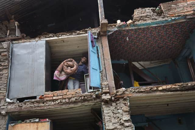 Rescue teams search in debris of collapsed houses after Saturday's earthquake in Bhaktapur, Nepal