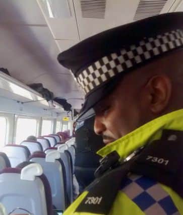 Police on board a crowded Brighton to London service which has been stranded for four hours near Clapham Junction due to a "major power supply problem".