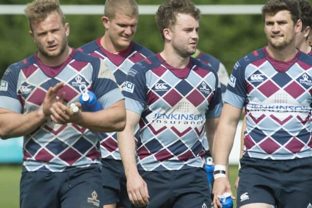 Dejected Titans players trudge off at the end of the game.