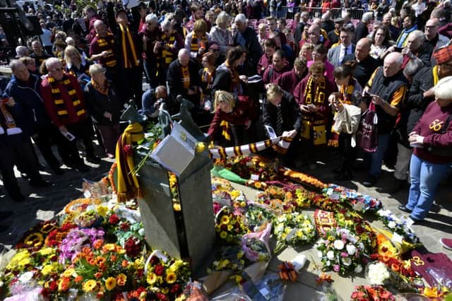 Mark Lawn, Phil Parkinson, David Helm and 1,000 more at the 30th anniversary commemoration of the Bradford City fire in the city's Centenary Square.  Picture: Bruce Rollinson