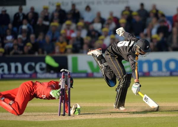 The stumps are broken by Lancashires Jos Buttler but Yorkshires Joe Root makes his ground to reach a half century. However, it was Buttler who had the ultimate say, leading the visitors to T20 victory at Headingley (Picture: Dave Williams).