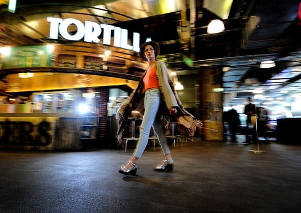 Poncho, £38; hat, feather straw fedora, £25; jeans, £42; silver shoes, £42; vest, £6; bag, £55. All in at Trinity Leeds Topshop.