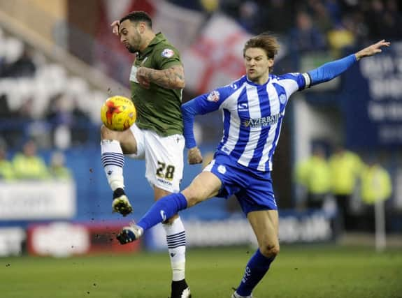 Owls skipper Glenn Loovens beats Craig Davies.