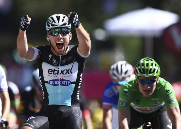 Britain's sprinter Mark Cavendish celebrates as he crosses the finish line.