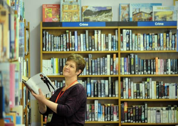 31/7/15  Volunteer  Angela Seed at Drighlington Library. (GL1006/71e)