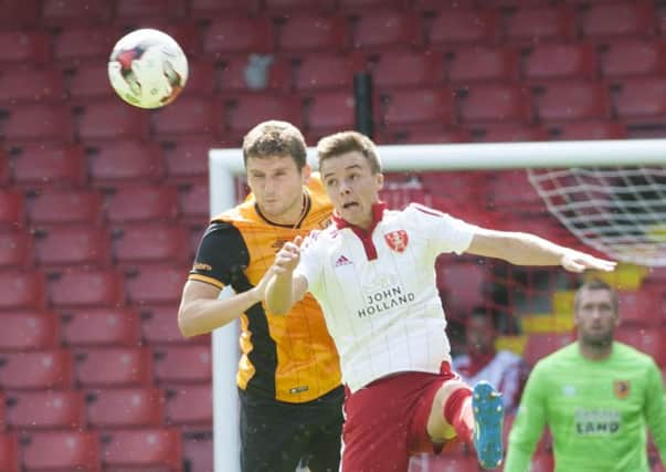 Hull City's 
Alex Bruce tangles with Stefan Scougall