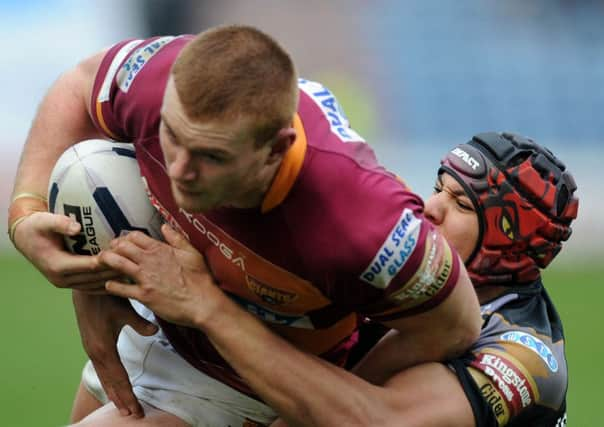 Jack Hughes holds off Ben Jones-Bishop to score for Huddersfield