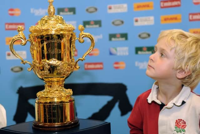 Toby Hopes, five, from Allerton Bywater near Leeds, with The Webb Ellis Trophy at Leeds Cental Library