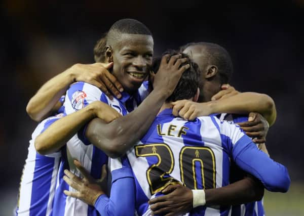 Kieran Lee is mobbed by delighted team-mates after scoring Sheffield Wednesdays third goal last night (Picture: Steve Ellis).