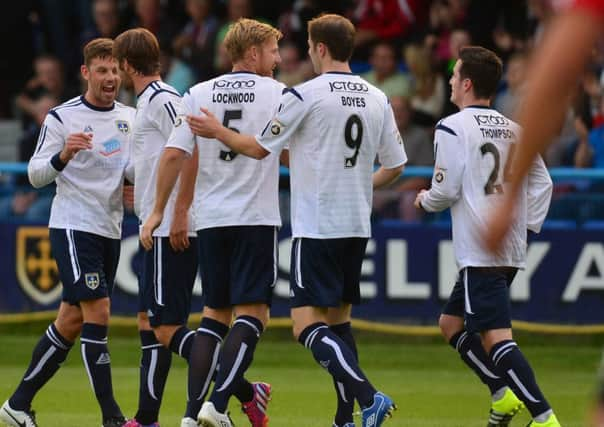 Guiseley players celebrate after Rob Atkinson (second left) scored their first goal during the Vanarama National League match at Nethermoor Park, Guiseley. (Picture: Anna Gowthorpe)