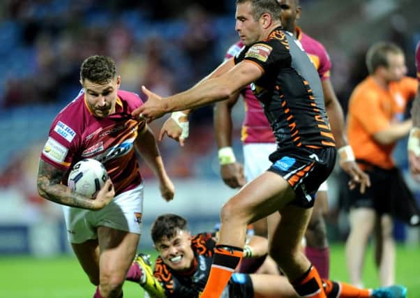 Huddersfield Giants Jamie Ellis powers through to score in his sides ultimately comprehensive victory over Castleford Tigers Picture: Jonathan Gawthorpe).