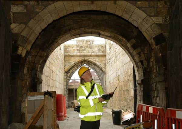 Uplifting: Archaeologist John Oxley looks at the hydraulic jacks that are being used on Walmgate Bar. Picture: Gary Longbottom