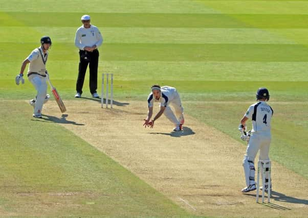 Yorkshires Jack Brooks closes his hands around the ball to accept a return catch off his bowling from Middlesexs Neil Dexter (Picture: Tony Johnson).