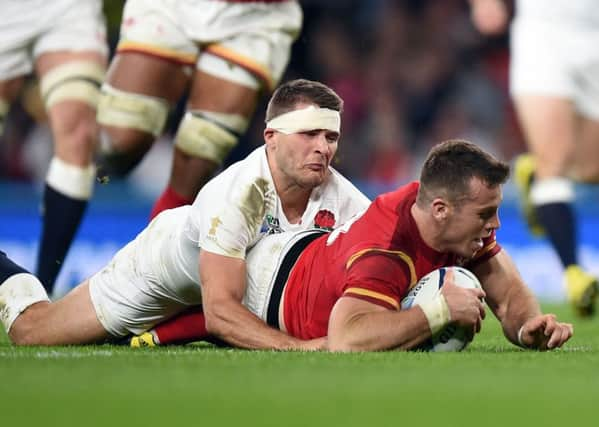 Wales' Gareth Davies dives in to score a try during the Rugby World Cup match at Twickenham Stadium, London.