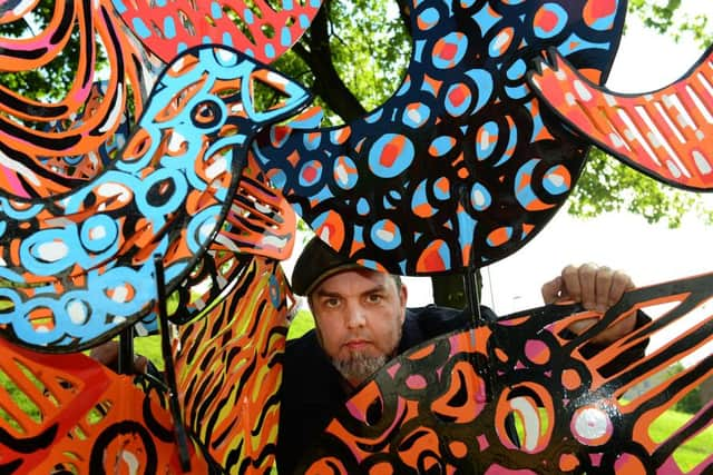 Paul Slater with his sculpture, which draws inspiration from birds and Barnsleys manufacturing history .Picture: Scott Merrylees