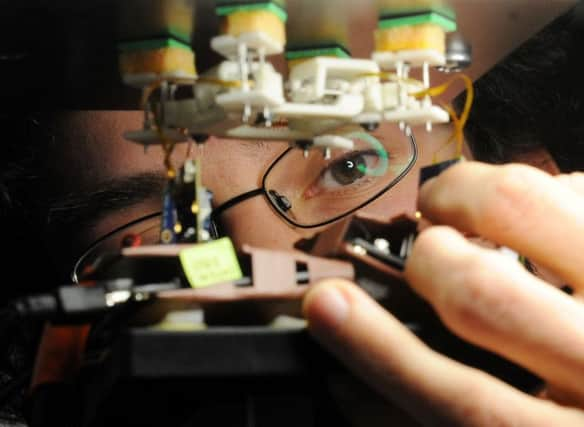 Alfonso Lopez pictured working on a robot in 2013, at the Mechanical Engineering department at Leeds University. The new drones are yet to be developed. Picture by Simon Hulme.