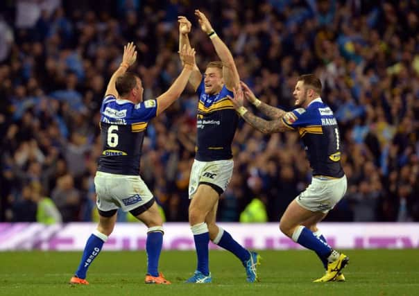 Jimmy Keinhorst, centre, celebrates Leeds Rhinos Grand Final win over Wigan Warriors with Danny McGuire, left, and Zak Hardaker at Old Trafford that completed the treble (Picture: Anna Gowthorpe/PA).