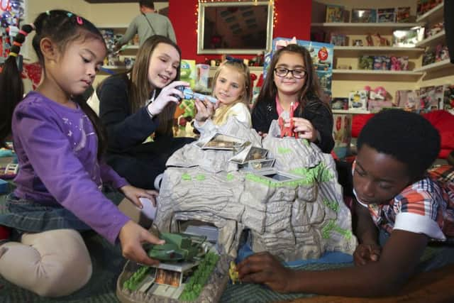 Children play with the Thunderbirds-Interactive Tracey Island, one of the top twelve toys at Dream Toys 2015, on display at St Mary's Church, London. Photo: Philip Toscano/PA Wire