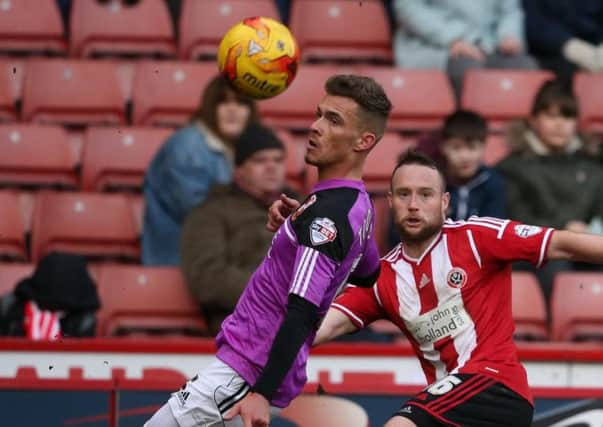 Harry Toffolo, left, in action for Swindon while on loan at the County Ground last season.