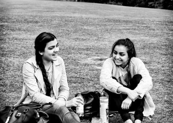 Two friends taking a break for lunch at Roundhay Park in Leeds