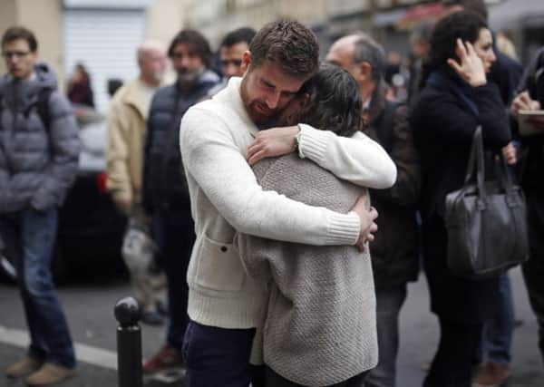 People react in front of   the Carillon cafe and the Petit Cambodge restaurant  in Paris