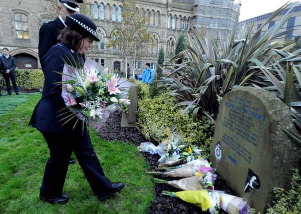 PC Sharon Beshenivsky's shift partner, who was shot and injured, Teresa Milburn, preparing to lay flowers.
Picture James Hardisty.