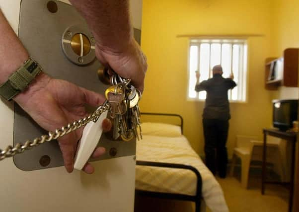 A prison cell door being locked.