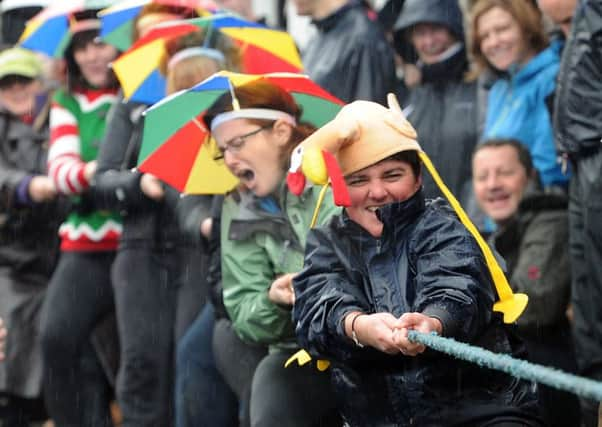 The ladies team from the Mother Shipton's Inn pull against theThe Half Moon team in the annual Boxing Day Knaresborough tug of war. The event took place on Abbey Road in front of the Half Moon pub after the River Nidd burst its banks at the venue flooding the area.  Picture Tony Johnson