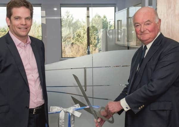 Michael Moore, J Marr (Seafoods) director, along with Andrew Marr of Andrew Marr International cut the ribbon to open the refurbished offices in Hessle