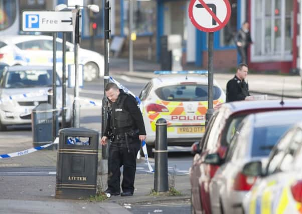 Police officers check bins near the scene of armed robbery at the Yorkshire Bank on Broad Street in Parkgate near Rotherham
Picture Dean Atkins