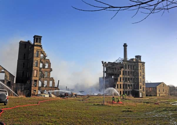 Firefighters damp down Drummonds Mill following a huge blaze which destroyed the building on Lumb Lane, Manningham in Bradford.  Picture Tony Johnson