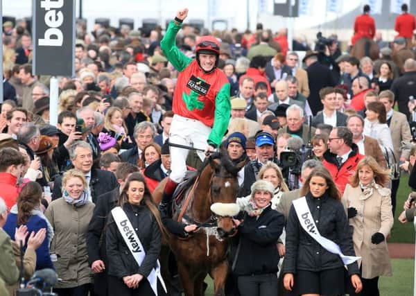 Winning jockey Sam Twiston-Davies celebrates on Dodging Bullets