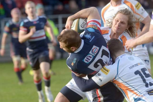 Doncaster Knights Simon Humberstone wriggles through to touch down as Yorkshire Carnegie defenders try to haul him down at Castle (Park. Picture: Gary Longbottom)