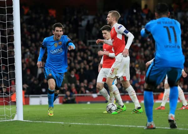 Barcelona's Lionel Messi celebrates (left) after scoring his side's first goal against Arsenal at the Emirates Stadium. Picture: Adam Davy/PA.