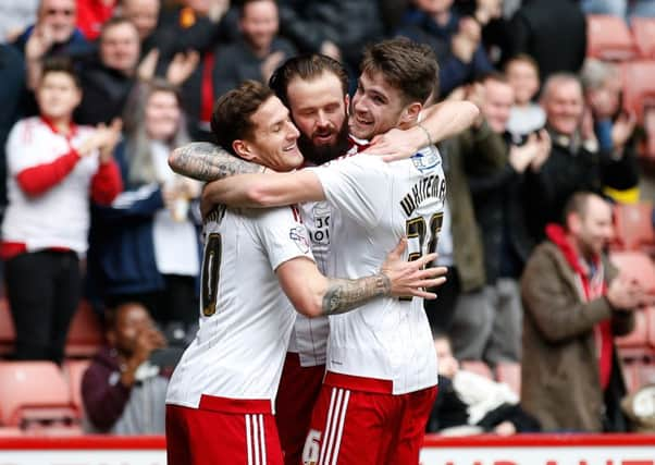 Sheffield Uniteds John Brayford celebrates with Billy Sharp and Ben Whiteman after scoring the first goal against Oldham Athletic at Bramall Lane (Picture: Simon Bellis/Sportimage).