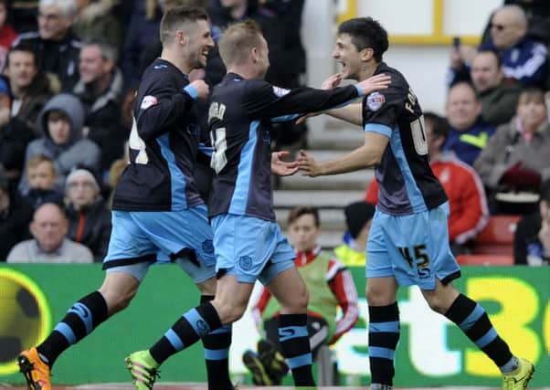 Sheffield Wednesday goalscorer Gary Hooper, left, and Barry Bannan rush to thank goal provider Fernando Forestieri.