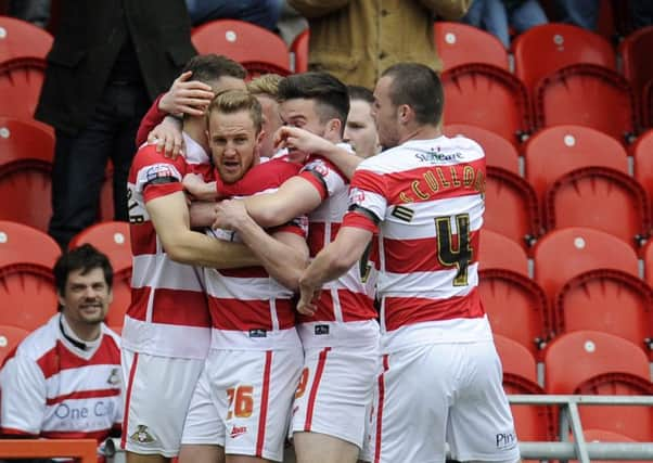 James Coppinger, second left, is congratulated by Doncaster Rovers team-mates after scoring the opening goal against Peterborough on his return from injury (Picture: Bruce Rollinson).