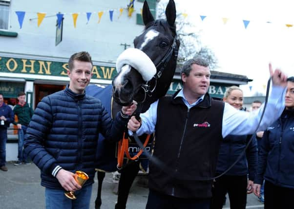 Trainer Gordon Elliott, right,  jockey Bryan Cooper and Don Cossack outside Shaw's Pub in Summerhill, County Meath