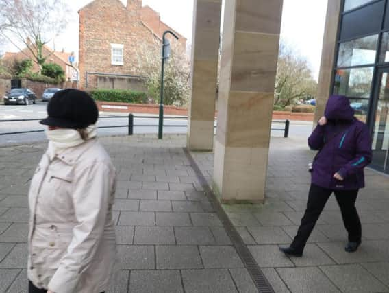 Camera shy...mother and daughter Joan and Rebecca Haire outside the court