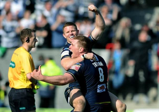 Hull FC's Scott Taylor lifts match-winner Steve Michaels at full time.