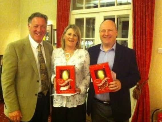 Incoming Huddersfield GC captain Parnell Reilly, left, with Easter social golf winners Cherrie and Nigel Myers.