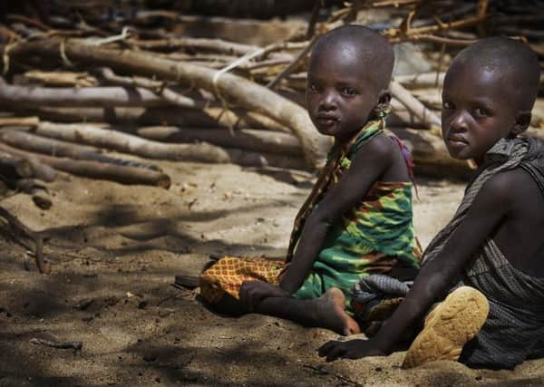 Two children wait for nutrition screenings at a UNICEF-assisted health centre near the town of Lodwar, capital of Turkana District, in Rift Valley Province.