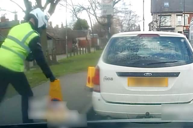 Dashcam footage of the warden moving a No Parking cone