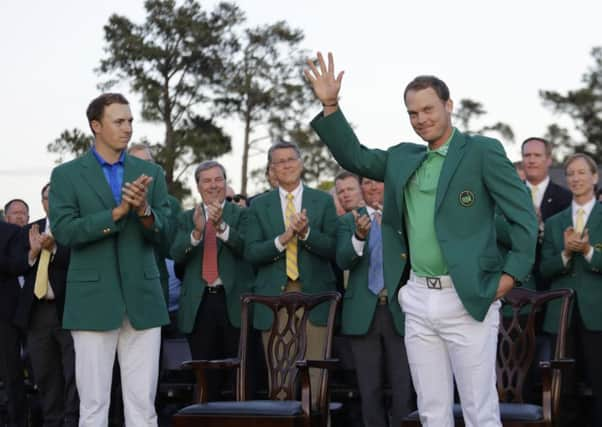 Defending champion Jordan Spieth, left, applauds as Masters champion Danny Willett, of England, waves after winning the Masters. (AP Photo/Jae C. Hong)