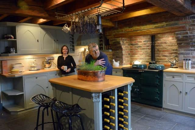 John and Tanya in the kitchen. The  units were repainted in Farrow and Ball's French Grey and the rack is from Sculp Steel with lavender from Wolds Way