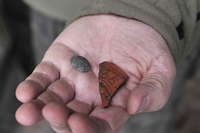 A button from the First World War and an ancient Roman plate fragment are discovered.
Picture: Richard Ponter
