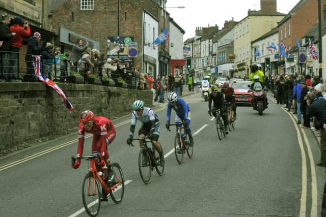 The peloton makes its way down Knaresborough High Street in the rain.  Picture: Gary Longbottom