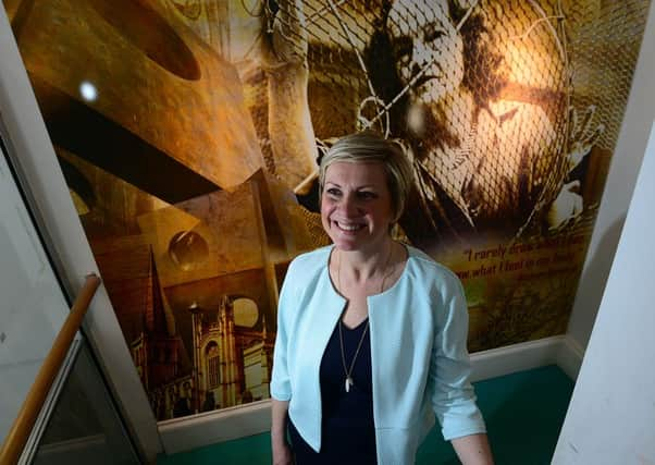 Headteacher of Wakefield Girls High School, Nina Gunson with a portrait of Barbara Hepworth in the school's Hepworth art block. Picture Scott Merrylees